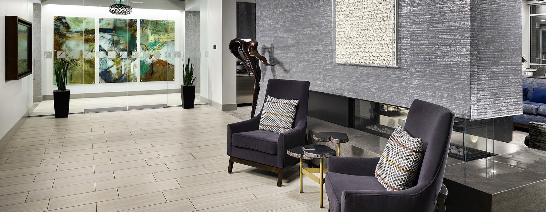 a room with a table, chairs and a fireplace