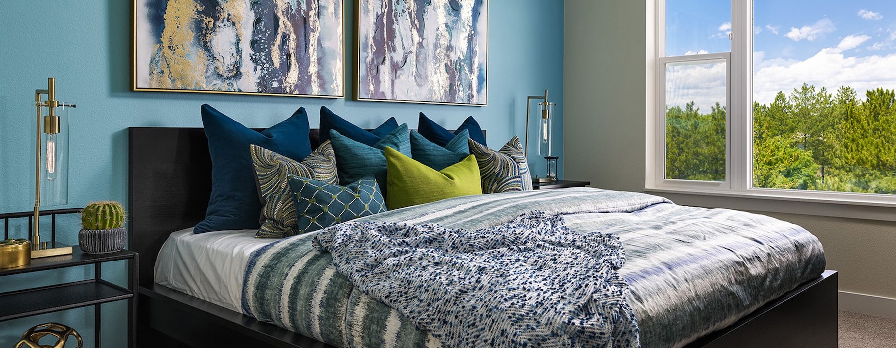 a bedroom with a bed and wall art